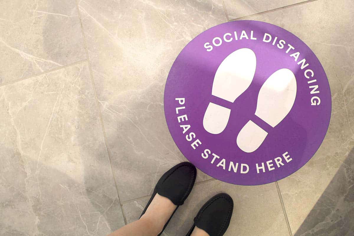 Universal_Sign_and_Graphics_Sign_Gallery_COVID 19_Signs__0011_purple-social-distancing-sign-on-the-floor-COVID 19 SIGNAG